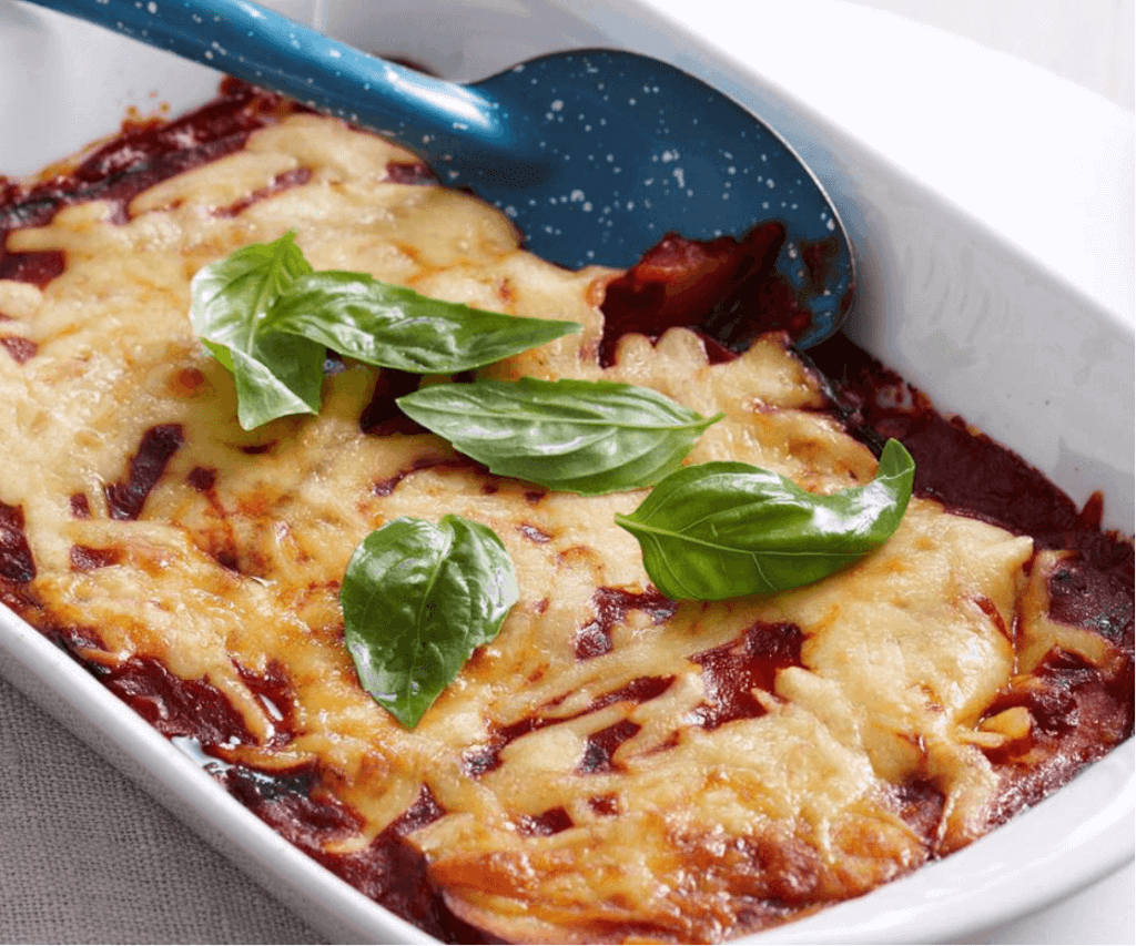 Eggplant parmegiana dish, with basil leaves on top